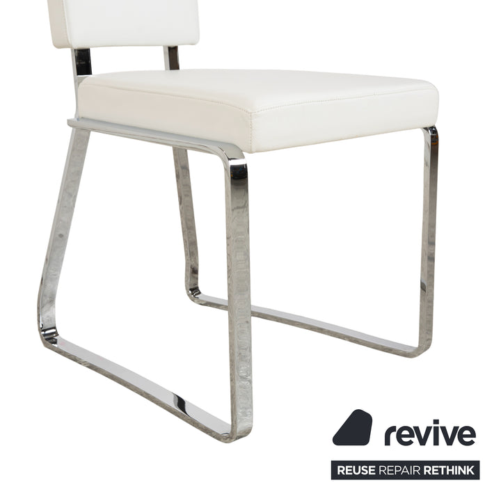 Ensemble de salle à manger Bacher en verre et cuir, comprenant une table et 8 chaises, finitions argent chromé, blanc et crème.