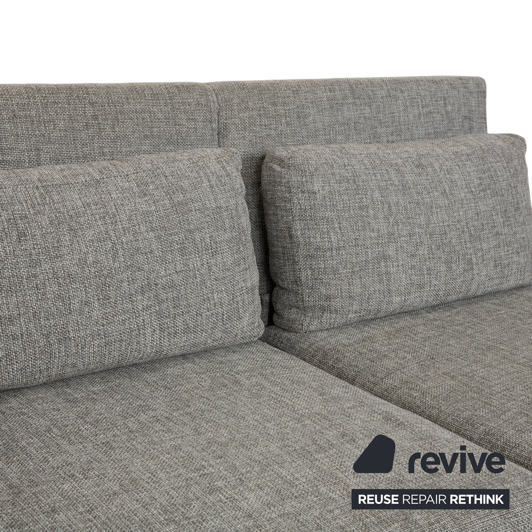 Canapé deux places en tissu gris Brühl Moule, avec fonction couchage.