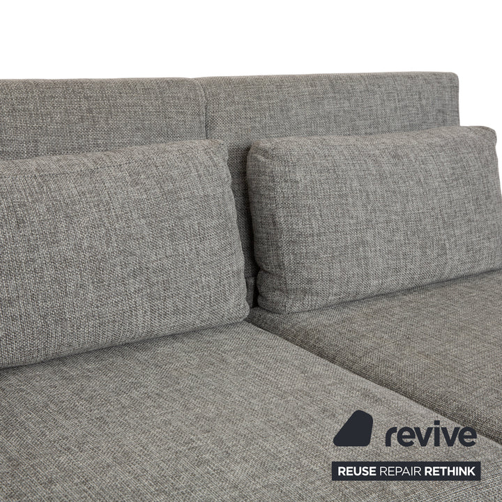 Canapé deux places en tissu gris Brühl Moule, avec fonction couchage.