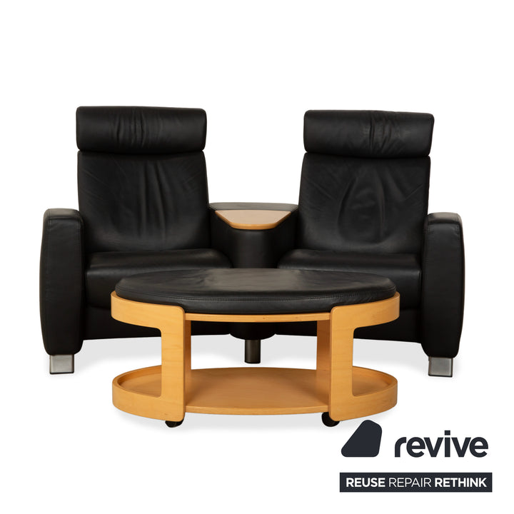 Table basse ottomane deux places Stressless Arion en cuir noir avec roulettes et fonction manuelle