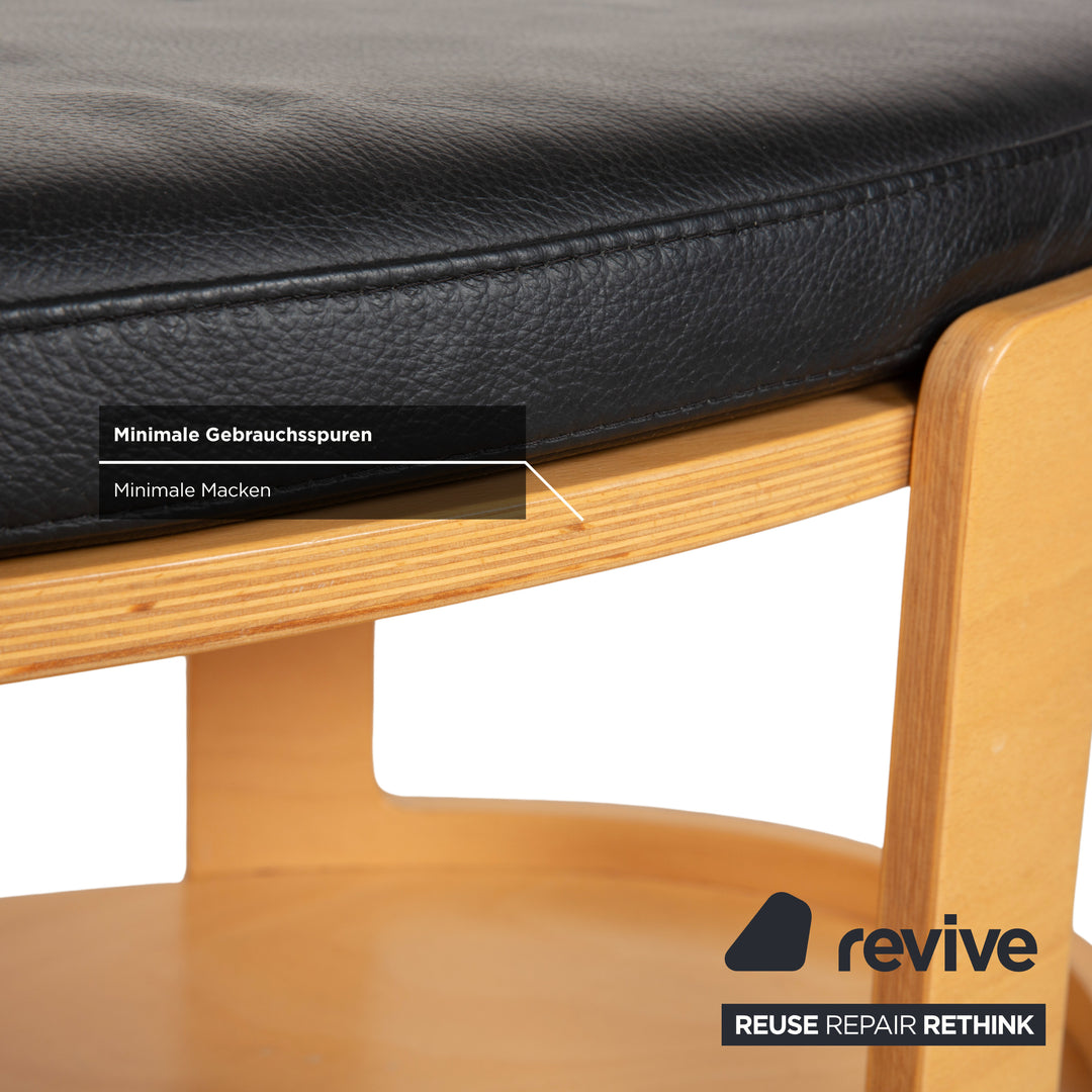 Table basse ottomane deux places Stressless Arion en cuir noir avec roulettes et fonction manuelle