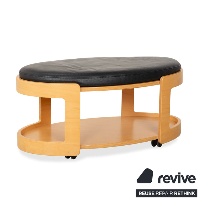 Table basse ottomane deux places Stressless Arion en cuir noir avec roulettes et fonction manuelle